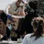 woman hands out supplies from truck